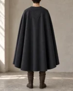 Asterhall Charcoal cloak rear view showing the small shield-shaped upper-back panel