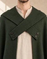 Waycross Moss Green cloak detail showing crossed cloth bands and button closures
